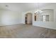 Open-concept living room featuring archways, a chandelier, and a view into the kitchen at 18617 E Arrowhead Trl, Queen Creek, AZ 85142