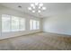 Spacious living room featuring neutral paint, plush carpet, and large windows at 18617 E Arrowhead Trl, Queen Creek, AZ 85142