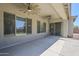 Covered patio with ceiling fans and large windows overlooking the backyard at 18617 E Arrowhead Trl, Queen Creek, AZ 85142