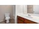 Bathroom featuring a single sink vanity and toilet with wood look flooring at 18896 N Lariat Rd, Maricopa, AZ 85138