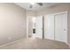 Carpeted bedroom featuring a closet and an open doorway to the ensuite bathroom at 18896 N Lariat Rd, Maricopa, AZ 85138