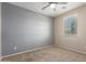 Bedroom with neutral carpet and a two-toned wall scheme, illuminated by natural light streaming through the window at 18896 N Lariat Rd, Maricopa, AZ 85138
