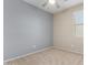 Neutral bedroom with a ceiling fan, carpet, and a window offering natural light at 18896 N Lariat Rd, Maricopa, AZ 85138