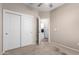 Bedroom featuring ample closet space, with an adjacent laundry room view at 18896 N Lariat Rd, Maricopa, AZ 85138