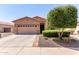 Charming single-story home featuring a desert landscape, a two-car garage, and a welcoming entrance at 18896 N Lariat Rd, Maricopa, AZ 85138