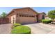 Front exterior of a single-story house with a two-car garage and well-maintained landscaping at 18896 N Lariat Rd, Maricopa, AZ 85138