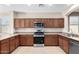 Functional kitchen with stainless steel appliances, wood cabinets, and ample counter space at 18896 N Lariat Rd, Maricopa, AZ 85138