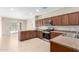 Kitchen featuring stainless steel appliances, wood cabinets, and an island with countertops at 18896 N Lariat Rd, Maricopa, AZ 85138