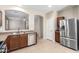 Bright kitchen with stainless steel appliances, wood cabinets, and views to other rooms at 18896 N Lariat Rd, Maricopa, AZ 85138