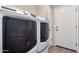Laundry area showcasing side-by-side washer and dryer units at 18896 N Lariat Rd, Maricopa, AZ 85138