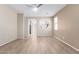 An empty living room featuring wood-look floors, a ceiling fan, and neutral-toned walls at 18896 N Lariat Rd, Maricopa, AZ 85138