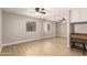 Spacious bedroom with mirrored closet, wood floors, ceiling fan, and vanity with a cushioned stool at 1920 W Lindner Ave # 116, Mesa, AZ 85202