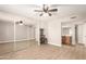 Bright bedroom featuring a ceiling fan, mirrored closet doors, wood floors, and access to the bathroom at 1920 W Lindner Ave # 116, Mesa, AZ 85202