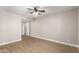 Spacious bedroom with wood floors, ceiling fan, and doorway leading to another room at 1920 W Lindner Ave # 116, Mesa, AZ 85202
