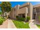 Beige two-story condo building with a lush green lawn and sidewalk at 1920 W Lindner Ave # 116, Mesa, AZ 85202