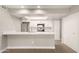 Modern white kitchen with breakfast bar and stainless steel appliances at 1920 W Lindner Ave # 116, Mesa, AZ 85202
