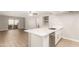 Open kitchen view showcasing quartz counters, wood floors, stainless steel appliances, and bright, natural light at 1920 W Lindner Ave # 116, Mesa, AZ 85202
