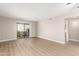 Bright living room with neutral paint, vinyl floors, and sliding glass doors at 1920 W Lindner Ave # 116, Mesa, AZ 85202