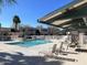 Community pool with lounge chairs and shade at 1920 W Lindner Ave # 116, Mesa, AZ 85202