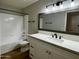 Updated bathroom with modern fixtures, a tiled shower, and vanity storage at 2025 E Campbell Ave # 132, Phoenix, AZ 85016