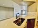Bright kitchen with laminate floors, modern appliances, and a view to the living room at 2025 E Campbell Ave # 132, Phoenix, AZ 85016