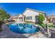 Serene backyard featuring a sparkling pool, lush landscaping, and a basketball hoop for outdoor enjoyment at 2028 S Esmeralda --, Mesa, AZ 85209