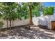 Brick-paved backyard featuring mature trees and a cozy fire pit with seating for relaxing evenings outdoors at 2028 S Esmeralda --, Mesa, AZ 85209