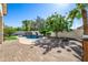 Inviting backyard featuring a pool, brick patio, fire pit, mature trees, and privacy wall, perfect for outdoor entertaining at 2028 S Esmeralda --, Mesa, AZ 85209