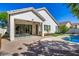 Backyard featuring brick and concrete patios, a covered patio, and a glimpse of the inviting pool at 2028 S Esmeralda --, Mesa, AZ 85209