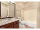 Bathroom features a modern sink, a large mirror, a toilet, and a shower/tub combo, combining functionality and style at 2028 S Esmeralda --, Mesa, AZ 85209