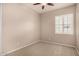 Empty bedroom with neutral paint, carpet flooring and a large window at 2028 S Esmeralda --, Mesa, AZ 85209
