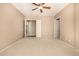 Empty bedroom with carpet, ceiling fan and doors leading to other rooms at 2028 S Esmeralda --, Mesa, AZ 85209