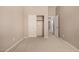 Bedroom features neutral walls, carpet, and a sliding closet door, offering ample storage and a doorway to other rooms at 2028 S Esmeralda --, Mesa, AZ 85209