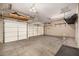 Spacious three-car garage with ample storage, overhead racks, and three garage doors, providing secure parking and organization at 2028 S Esmeralda --, Mesa, AZ 85209