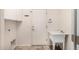 Functional laundry room with a utility sink, storage cabinets, and a back door, blending practicality and convenience at 2028 S Esmeralda --, Mesa, AZ 85209