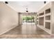 Spacious living room with wood floors, ceiling fan, and sliding glass doors to the outdoor patio at 2028 S Esmeralda --, Mesa, AZ 85209