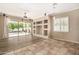 Bright living room featuring a ceiling fan, built-in shelving, and sliding glass doors to the backyard at 2028 S Esmeralda --, Mesa, AZ 85209