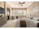 Comfortable main bedroom with ceiling fan, carpet floors, large windows and a view to the ensuite bath at 2028 S Esmeralda --, Mesa, AZ 85209