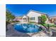 Backyard pool with a basketball hoop near a bright, white stucco home under a clear, sunny sky at 2028 S Esmeralda --, Mesa, AZ 85209