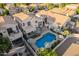 Stunning home showcasing a refreshing pool, outdoor seating, upper deck, and mature landscaping at 213 E Vaughn Ave, Gilbert, AZ 85234