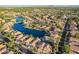 Stunning aerial view of lakeside homes featuring well-manicured lawns and community lake access at 213 E Vaughn Ave, Gilbert, AZ 85234