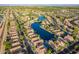 An expansive aerial view showcasing a desert community with beautiful lake views and well-maintained landscaping at 213 E Vaughn Ave, Gilbert, AZ 85234