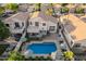 A beautiful home with a pristine pool, covered patio, upstairs deck, and well-maintained landscaping at 213 E Vaughn Ave, Gilbert, AZ 85234