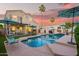 Inviting backyard pool with lush landscaping and ample seating under shade umbrellas at 213 E Vaughn Ave, Gilbert, AZ 85234