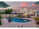 Expansive backyard with a large pool, patio area, balcony, and desert landscaping at 213 E Vaughn Ave, Gilbert, AZ 85234