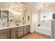 This bathroom offers a tub, double vanity, and natural light at 213 E Vaughn Ave, Gilbert, AZ 85234
