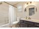 Bathroom with a shower/tub combo, modern lighting, and a vanity at 213 E Vaughn Ave, Gilbert, AZ 85234
