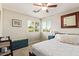 Cozy bedroom with an upholstered storage bench, natural light, and neutral colors at 213 E Vaughn Ave, Gilbert, AZ 85234