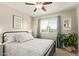 Comfortable bedroom with a ceiling fan, blue curtains, and natural light at 213 E Vaughn Ave, Gilbert, AZ 85234