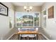 Cozy dining nook featuring a rustic wood table, bright natural light, and views to the outdoors at 213 E Vaughn Ave, Gilbert, AZ 85234